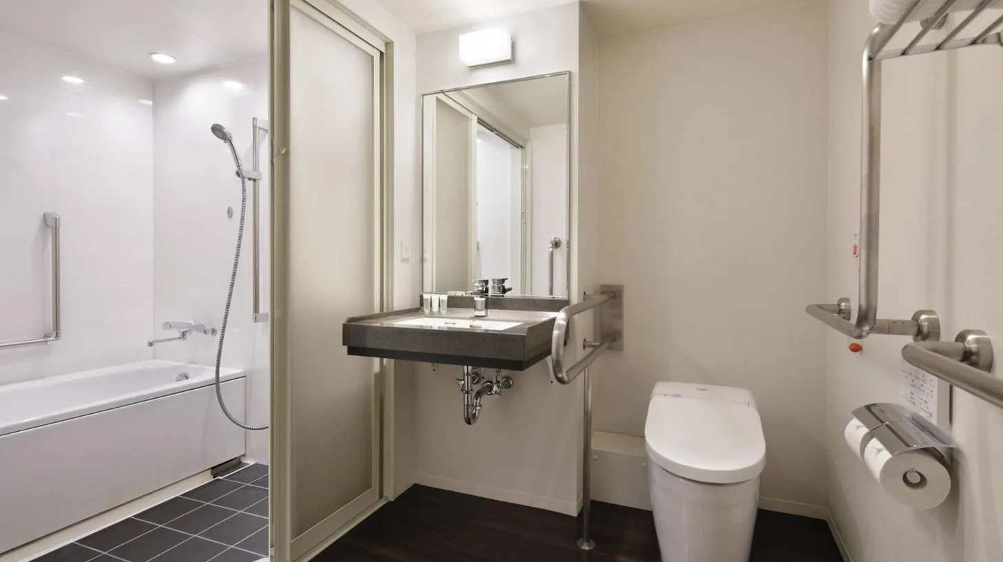 a bathroom with a sink and a toilet at Courtyard by Marriott Shin-Osaka Station in Osaka
