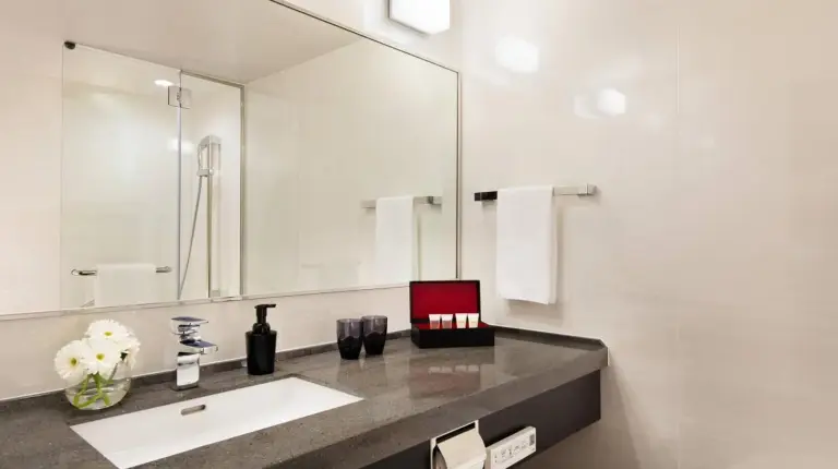 a bathroom with a sink and a mirror at Courtyard by Marriott Shin-Osaka Station in Osaka