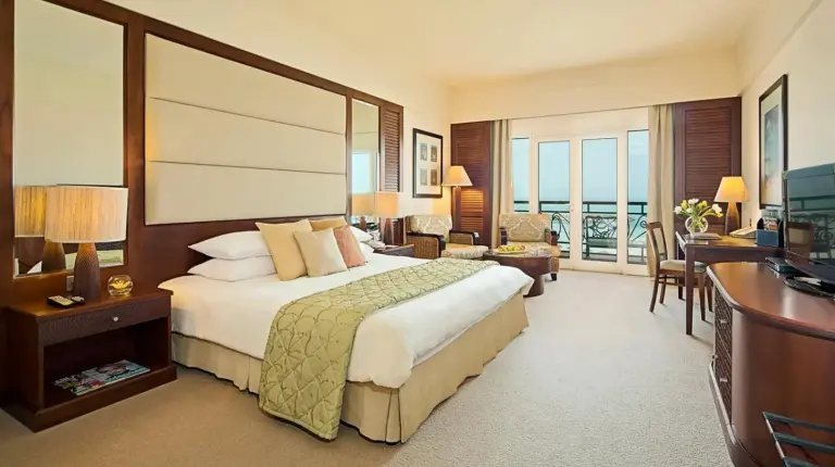 a hotel room with a bed and a television at Danat Jebel Dhanna Resort in Jebel Dhanna