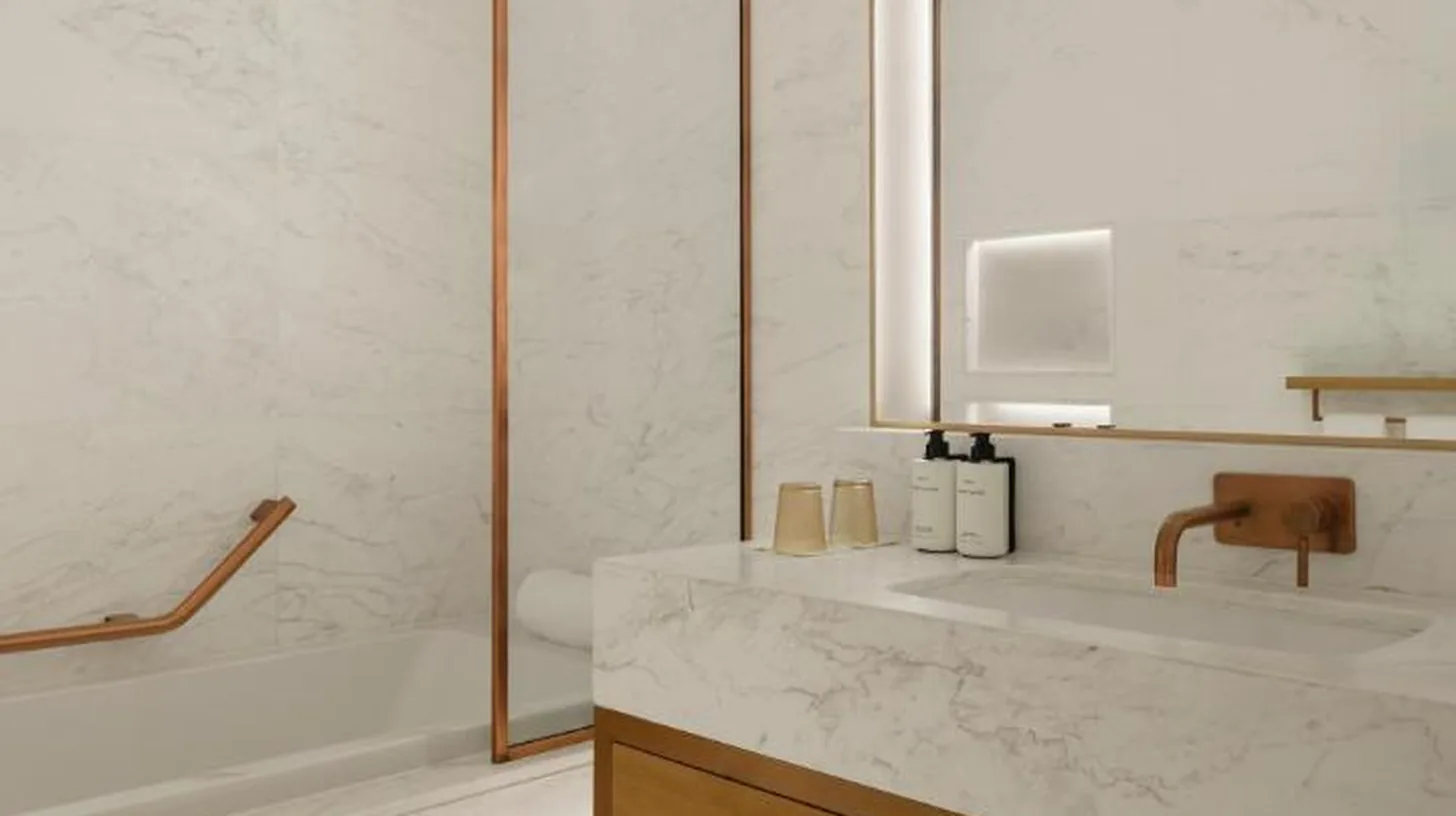 two perfume bottles sitting on a counter in a bathroom at Delano Dubai at Bluewaters in Dubai