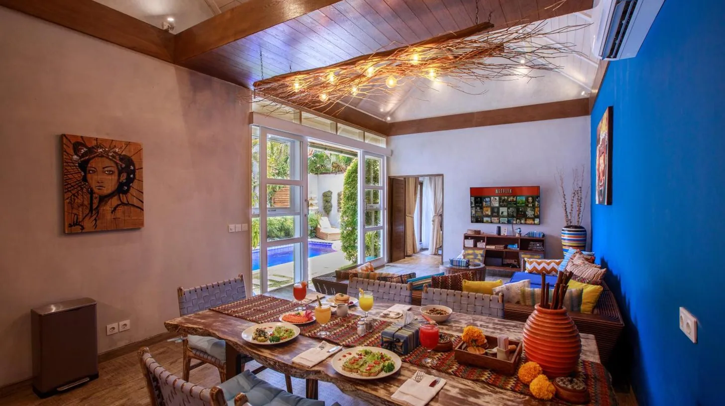 a living room with a table with food on it at Delight ART Villas in Seminyak