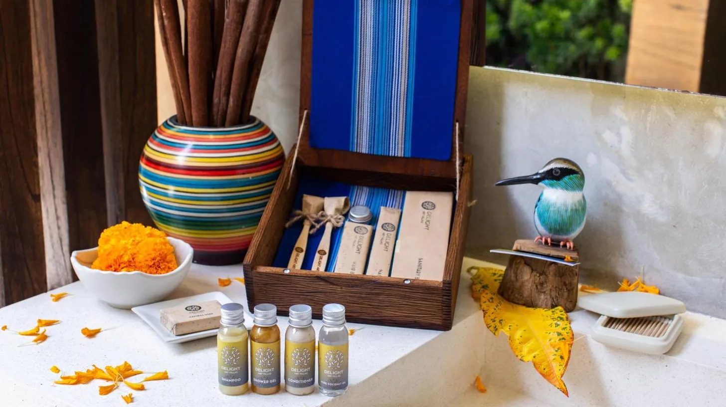 a table with a box of books and a bird on it at Delight ART Villas in Seminyak