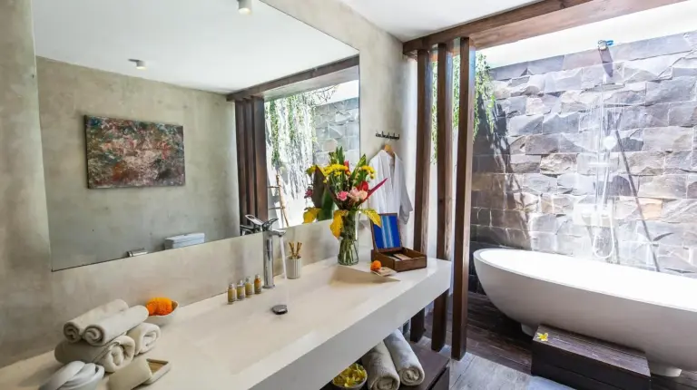 a bathroom with a tub and a sink at Delight ART Villas in Seminyak