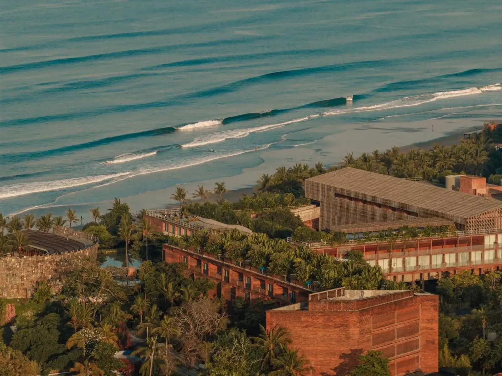 Aerial view of Desa Potato Head Bali showcasing lush surroundings and beachfront