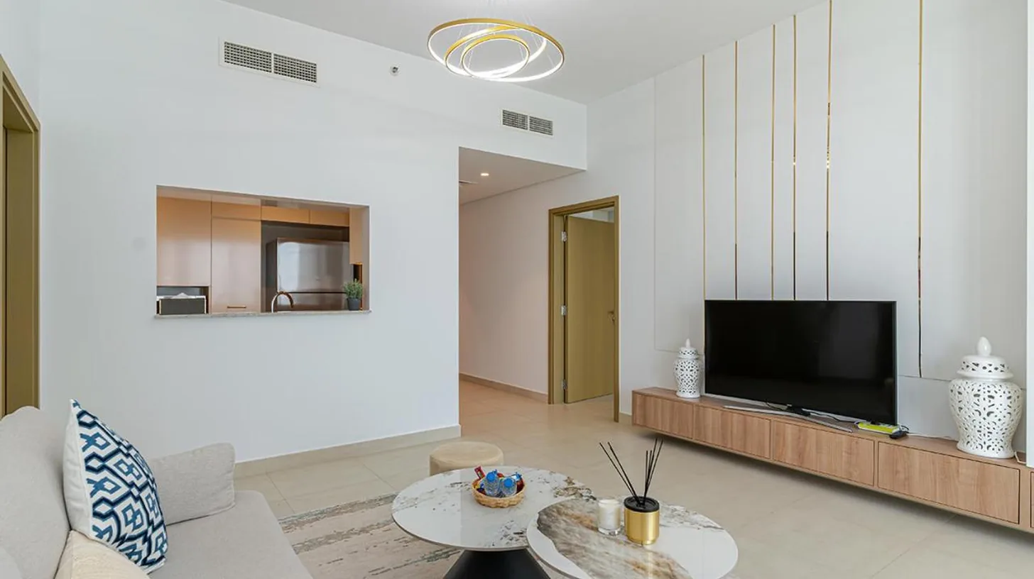 a living room with a couch and a tv at Downtown Views 4702 in Dubai