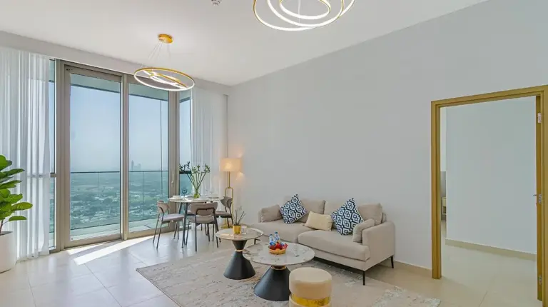 a living room with a tv and a potted plant at Downtown Views 4702 in Dubai