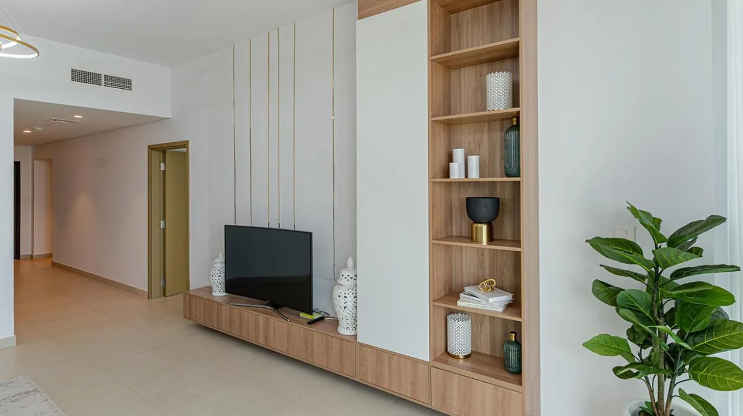 a living room with a table and a couch at Downtown Views 4702 in Dubai