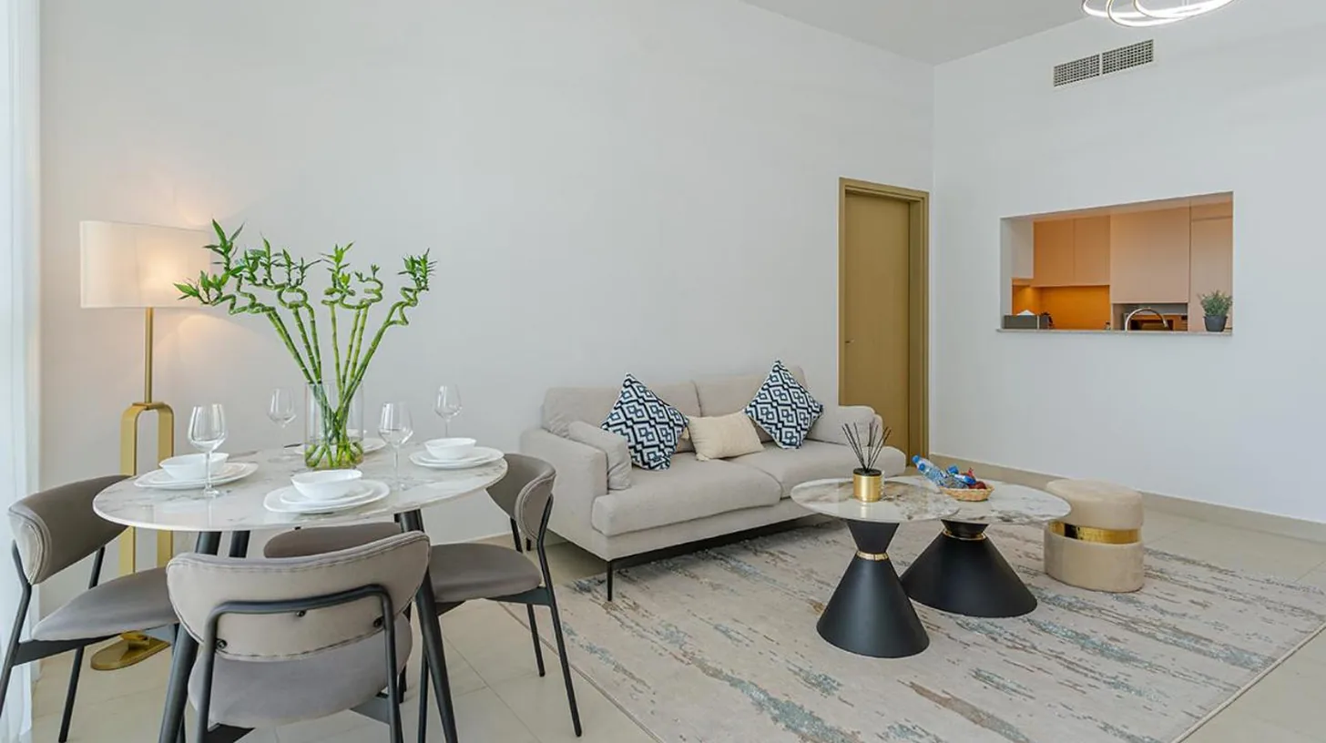 a white closet with white doors and shelves at Downtown Views 4702 in Dubai