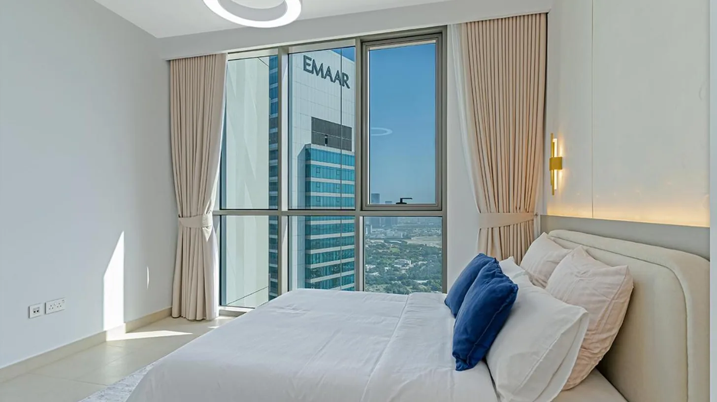 a bathroom with a toilet and a wooden door at Downtown Views 4702 in Dubai