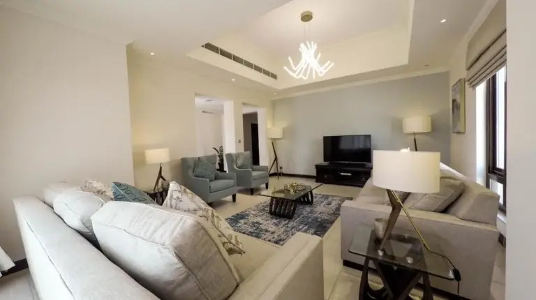 a living room with a couch and a tv at Elara & Golf Villas - curated by Park Hyatt Dubai in Dubai