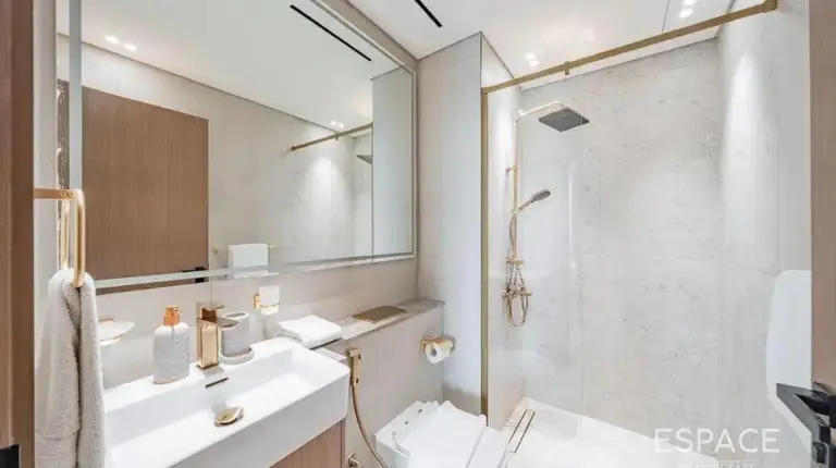 a bathroom with a toilet and a sink and a shower at Elegant 2BR Private Pool Apart At Binghatti Orchid JVC in Dubai