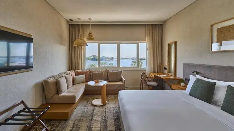 a hotel room with a bed and a couch at ERTH Abu Dhabi Hotel in Abu Dhabi