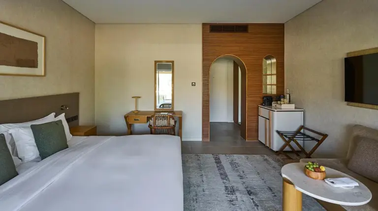 a table and chairs in a room with a kitchen at ERTH Abu Dhabi Hotel in Abu Dhabi
