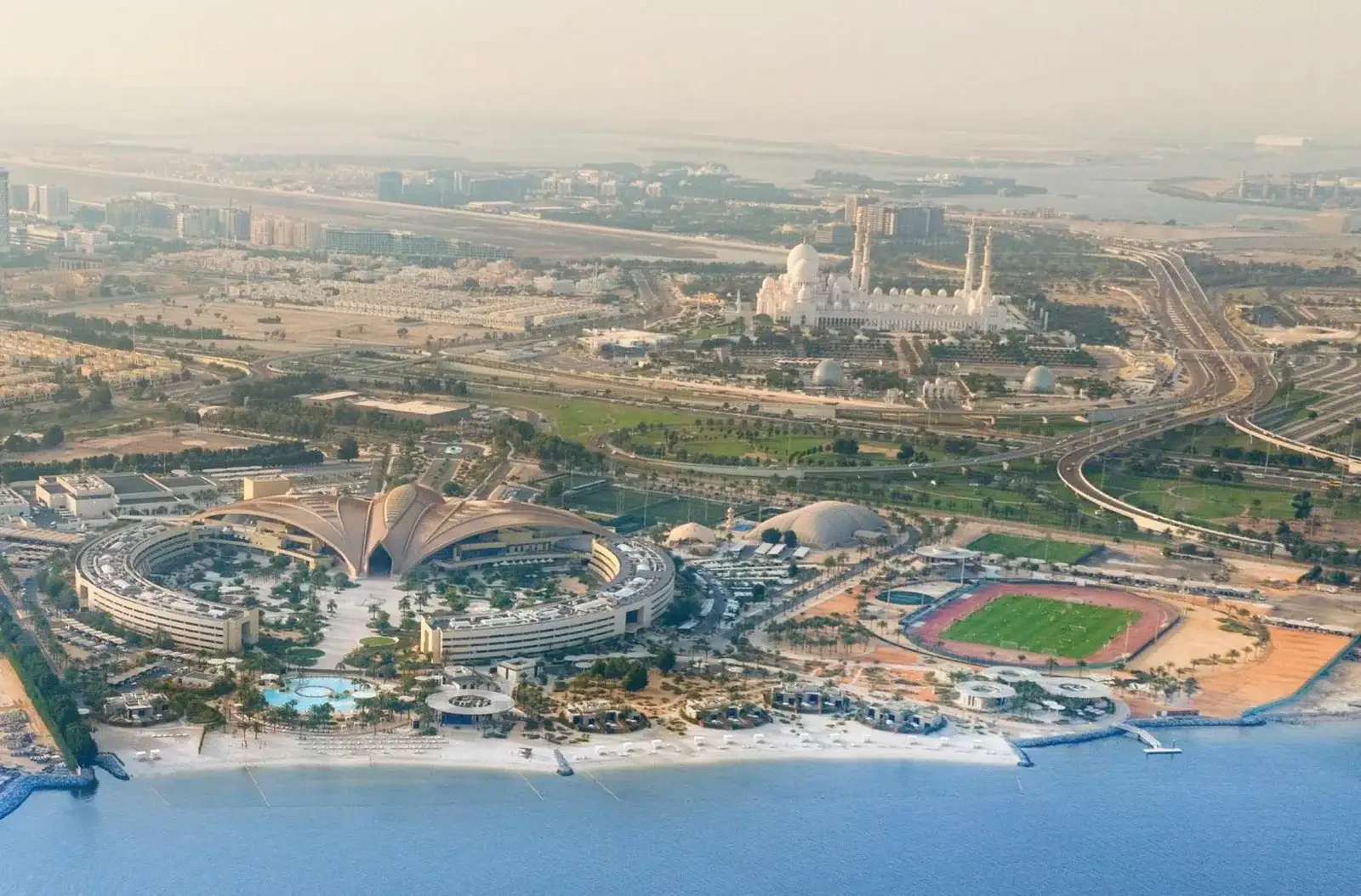 Aerial view of ERTH Abu Dhabi Hotel showcasing its architecture and nearby amenities