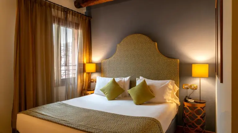 a bedroom with a large bed and a chair at Excess Venice Boutique Hotel & Private Spa - Adults Only in Venice