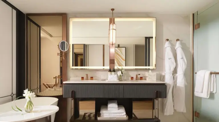 a bathroom with a sink and a large mirror at Fairmont Bangkok Sukhumvit in Bangkok