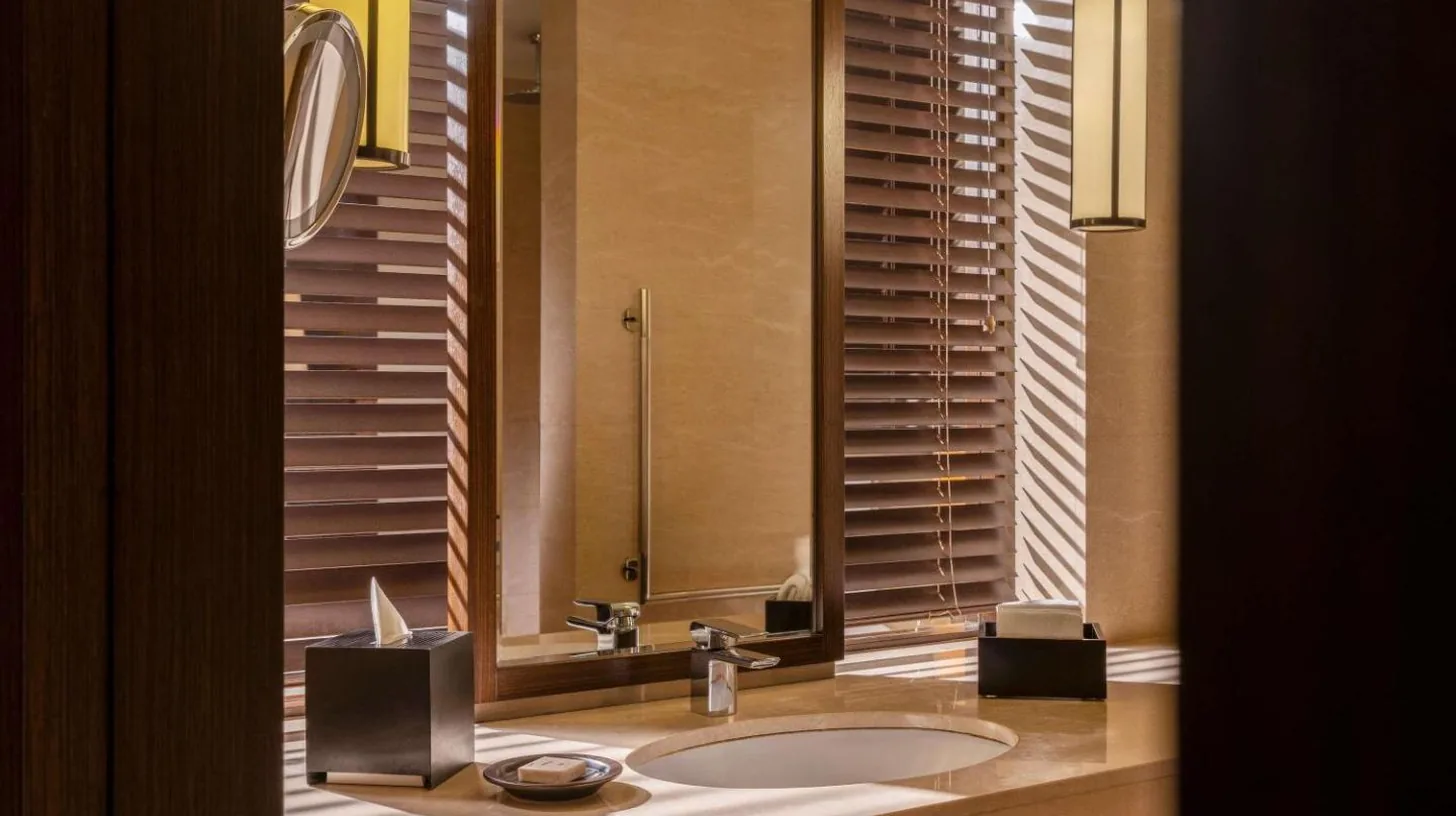 a bathroom with a sink and a mirror at Fairmont Jakarta in Jakarta