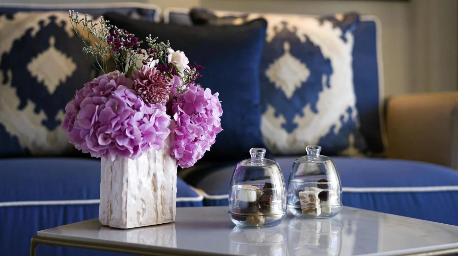 a table with a vase of purple flowers on it at Fairmont Tazi Palace Tangier in Tangier