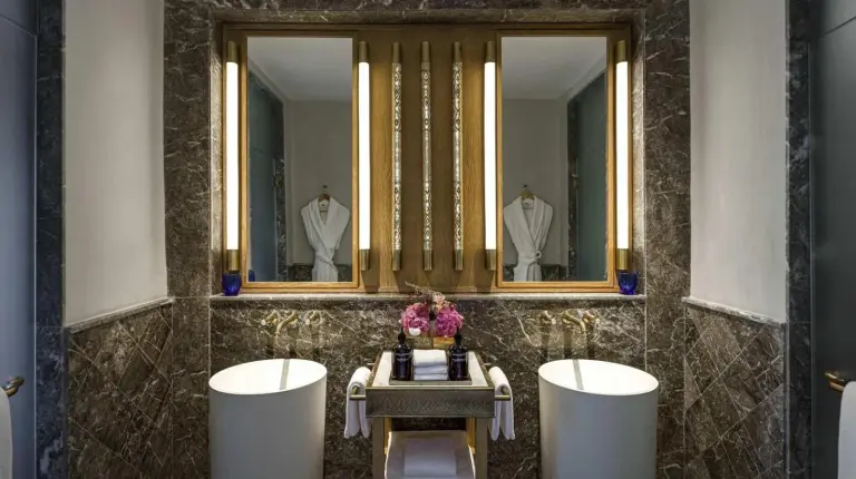 a bathroom with two sinks and two mirrors at Fairmont Tazi Palace Tangier in Tangier