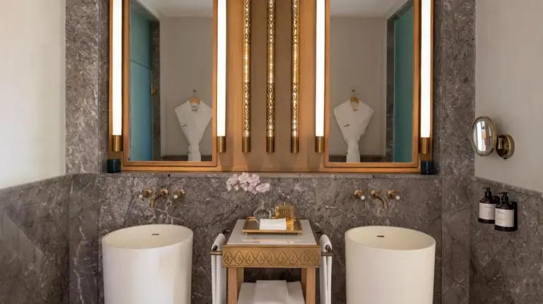 a bathroom with two stools and a table and two mirrors at Fairmont Tazi Palace Tangier in Tangier