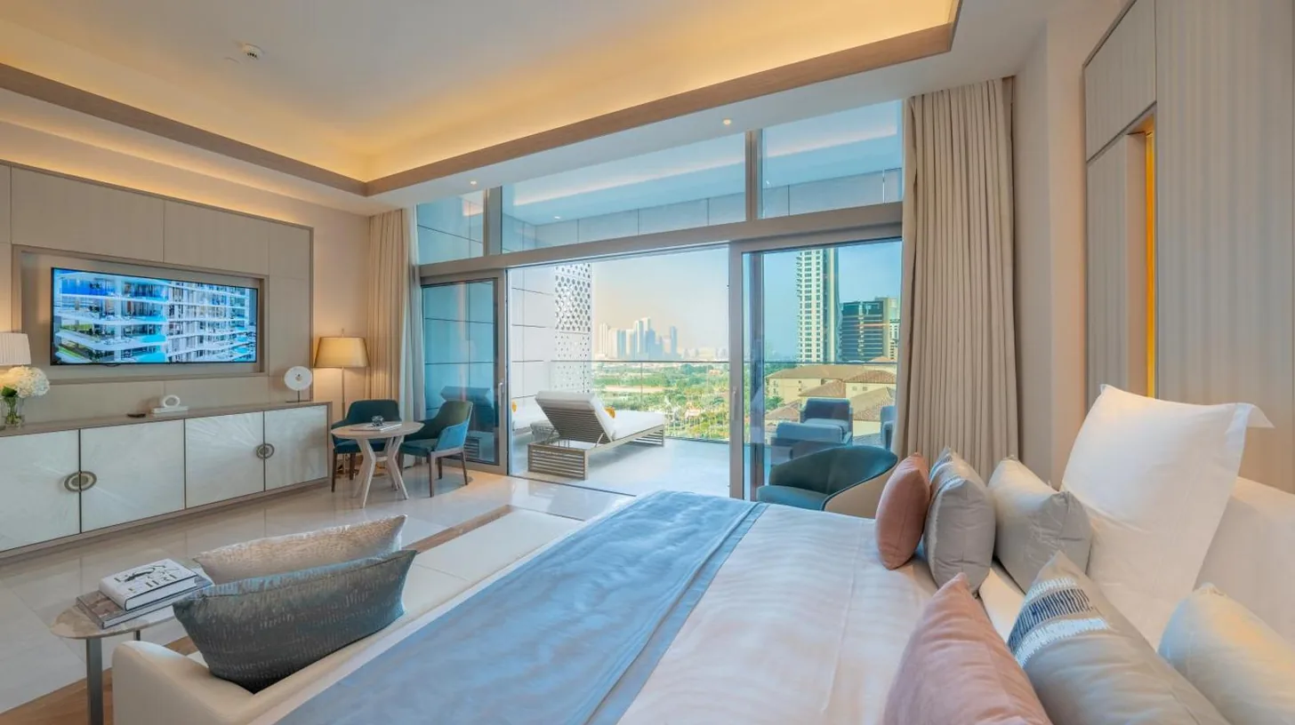 a bedroom with a large bed and a living room at FIVE LUXE in Dubai