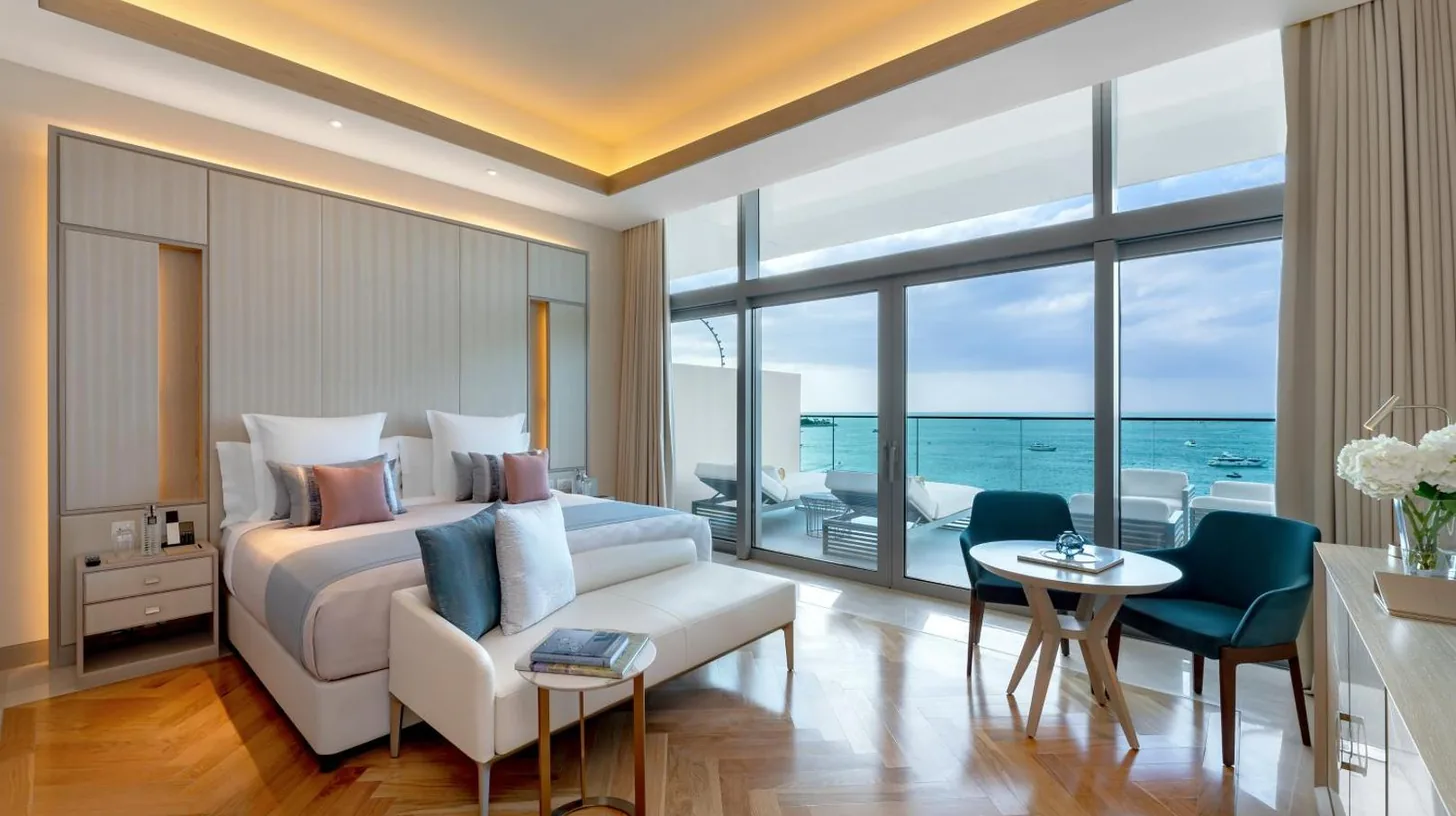 a bedroom with a large white bed and a desk at FIVE LUXE in Dubai