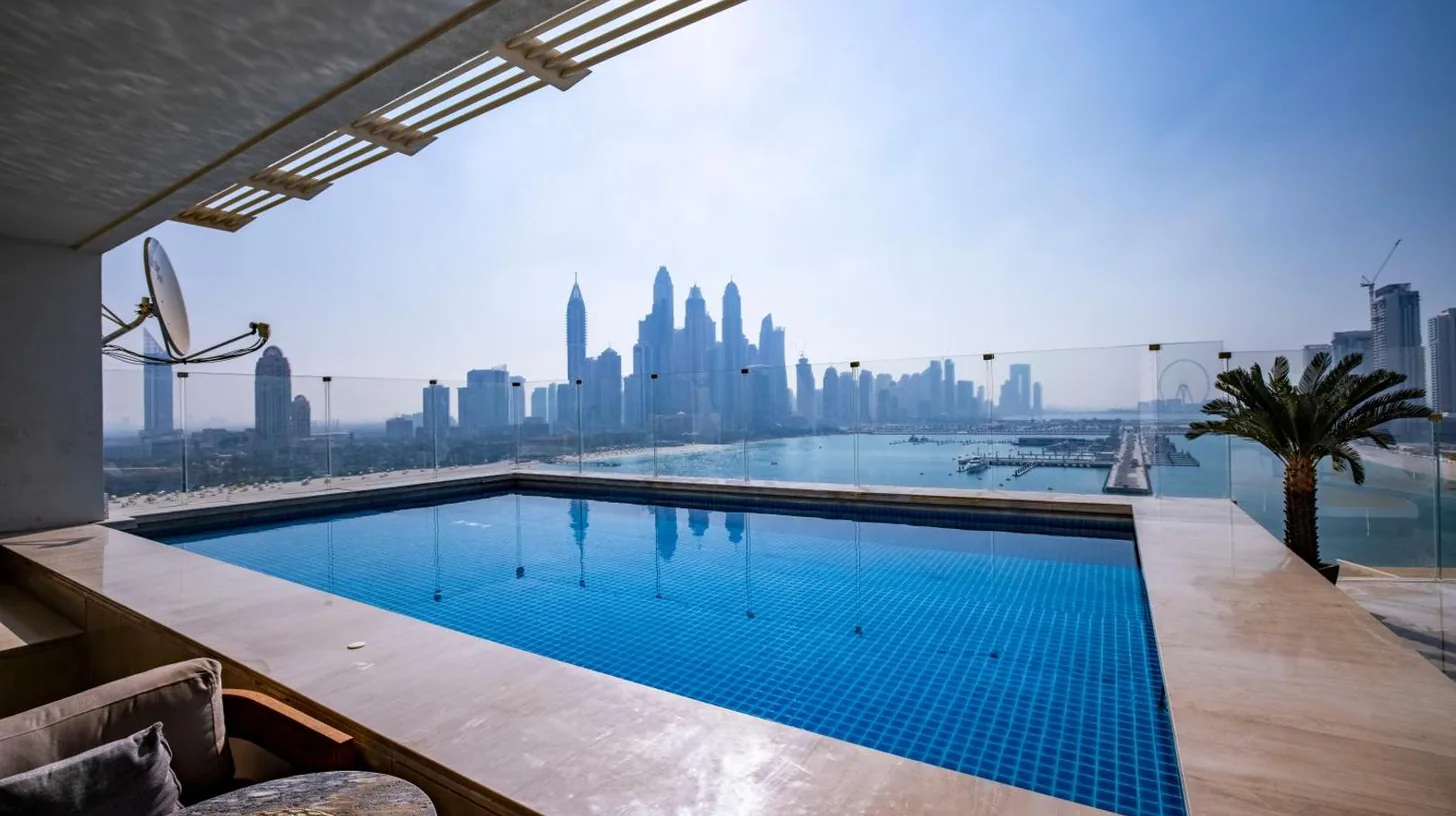 a swimming pool with a view of the city at FIVE Palm Jumeirah 2BR Luxury Penthouse