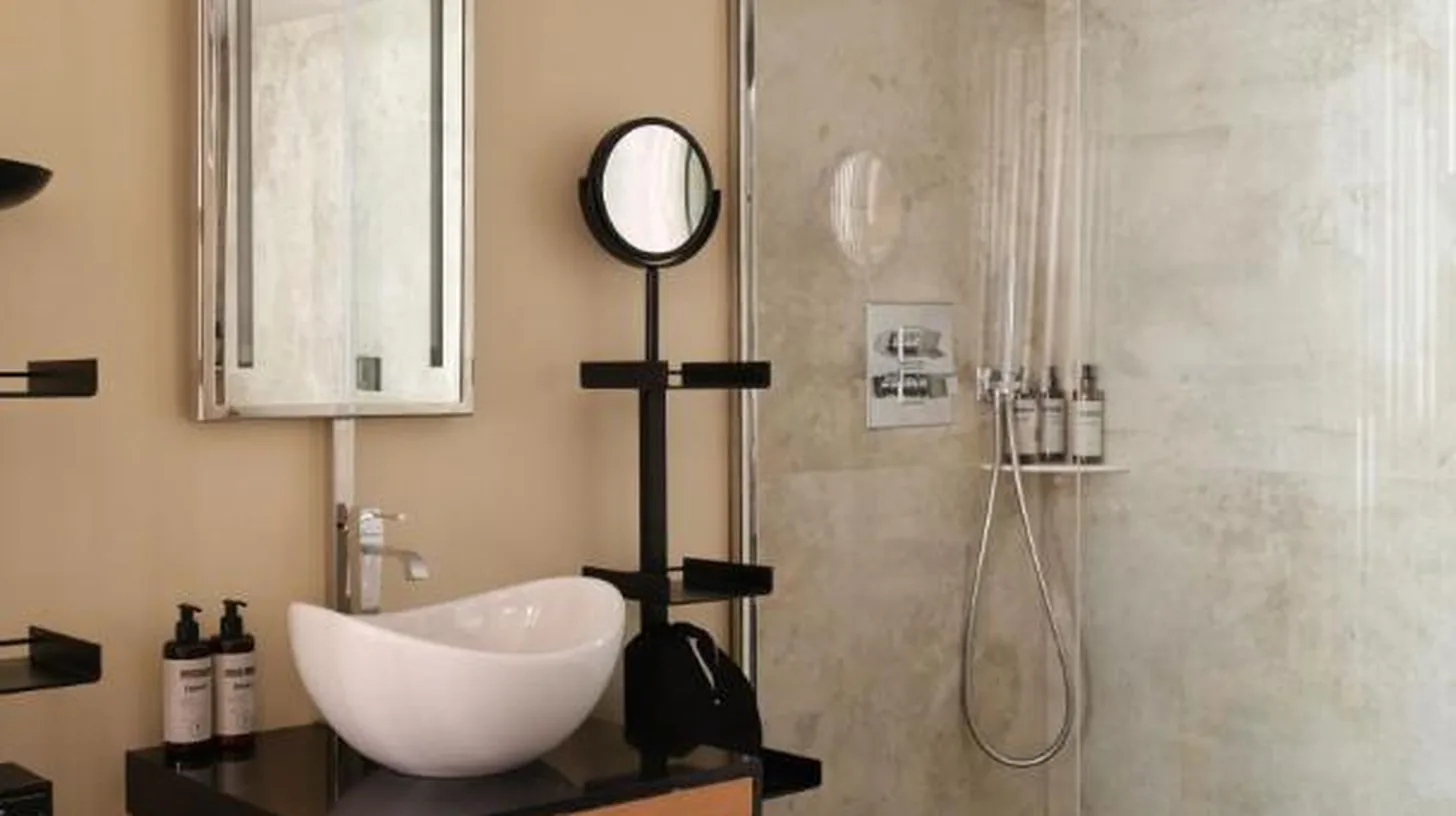 a bathroom with a sink and a shower at Five Seas by Inwood Hotels in Cannes