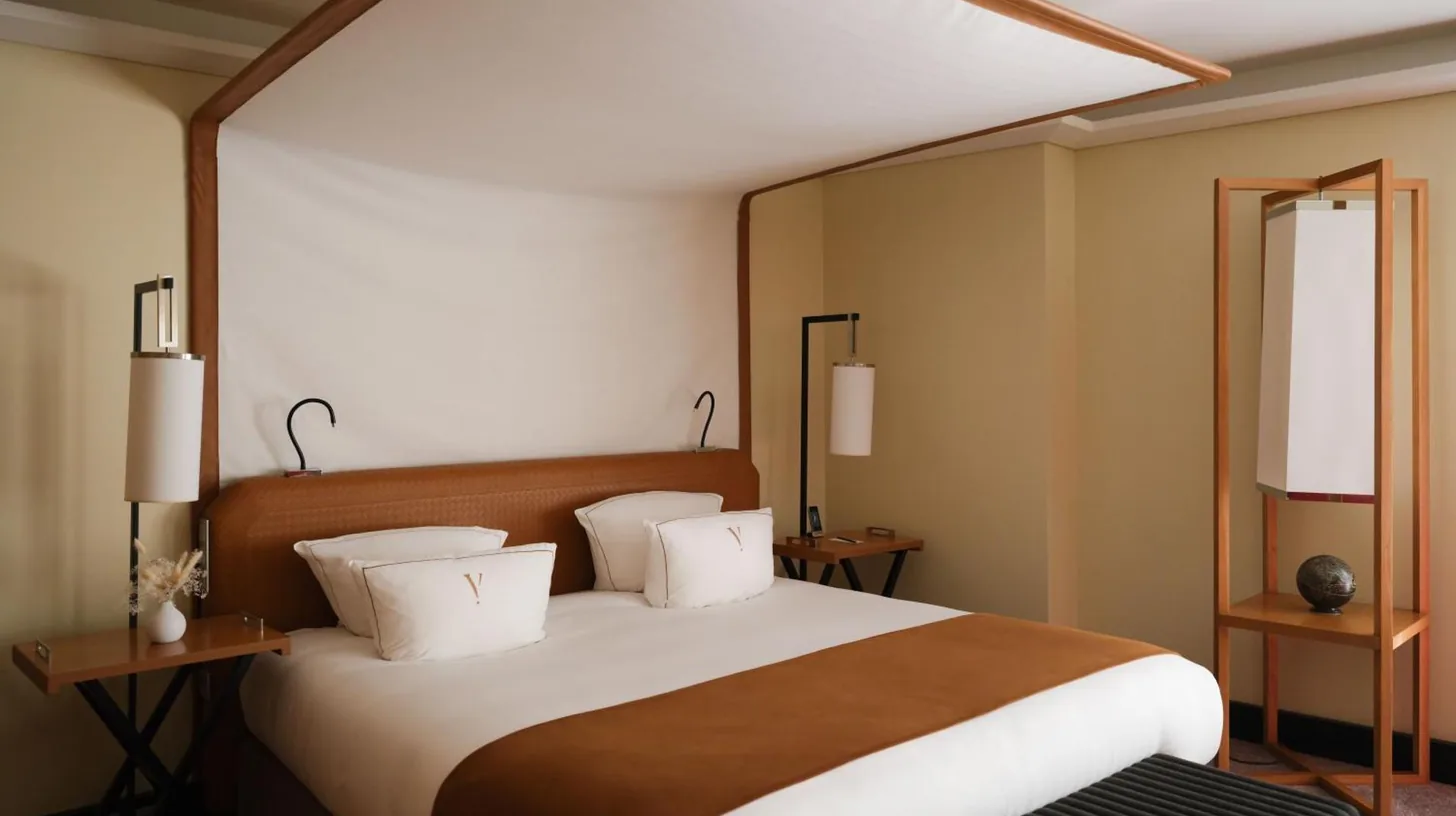 a hotel room with a couch and a red chair at Five Seas by Inwood Hotels in Cannes