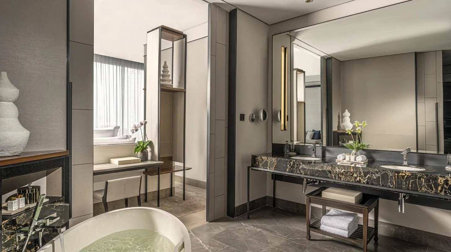 un baño con dos lavabos y un espejo en Four Seasons Hotel Bangkok at Chao Phraya River en Bangkok