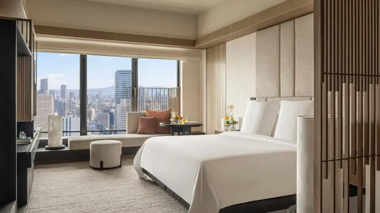 a bedroom with a large white bed and a large window at Four Seasons Hotel Osaka in Osaka