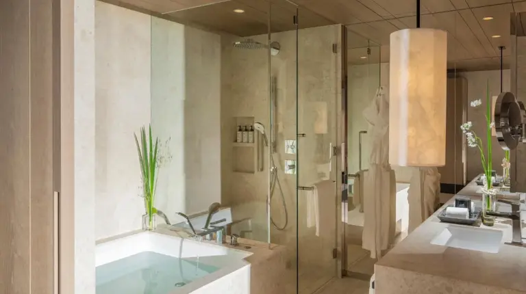 a bathroom with a shower and a sink and a tub at Four Seasons Hotel Osaka in Osaka
