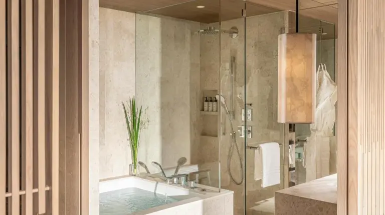 a bathroom with a sink and a shower and a tub at Four Seasons Hotel Osaka in Osaka