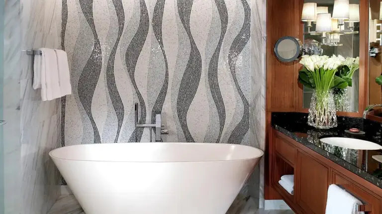 a bathroom with a white tub and a sink at Four Seasons Resort Dubai at Jumeirah Beach in Dubai