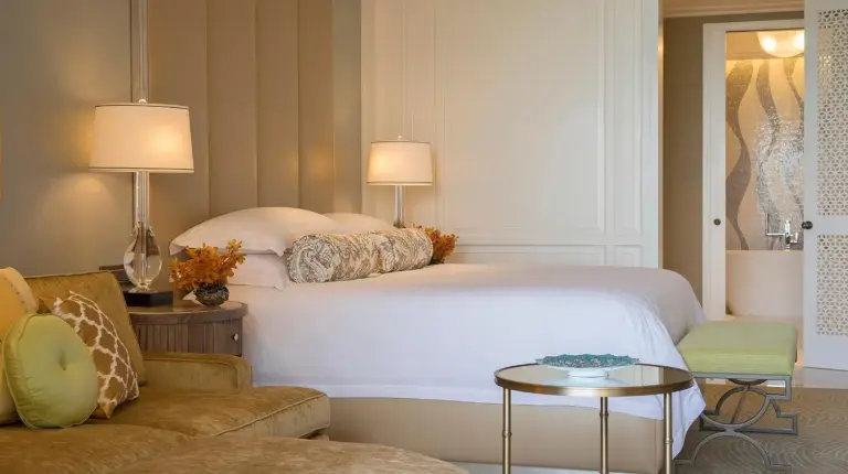 a bedroom with a large bed and a blue couch at Four Seasons Resort Dubai at Jumeirah Beach in Dubai
