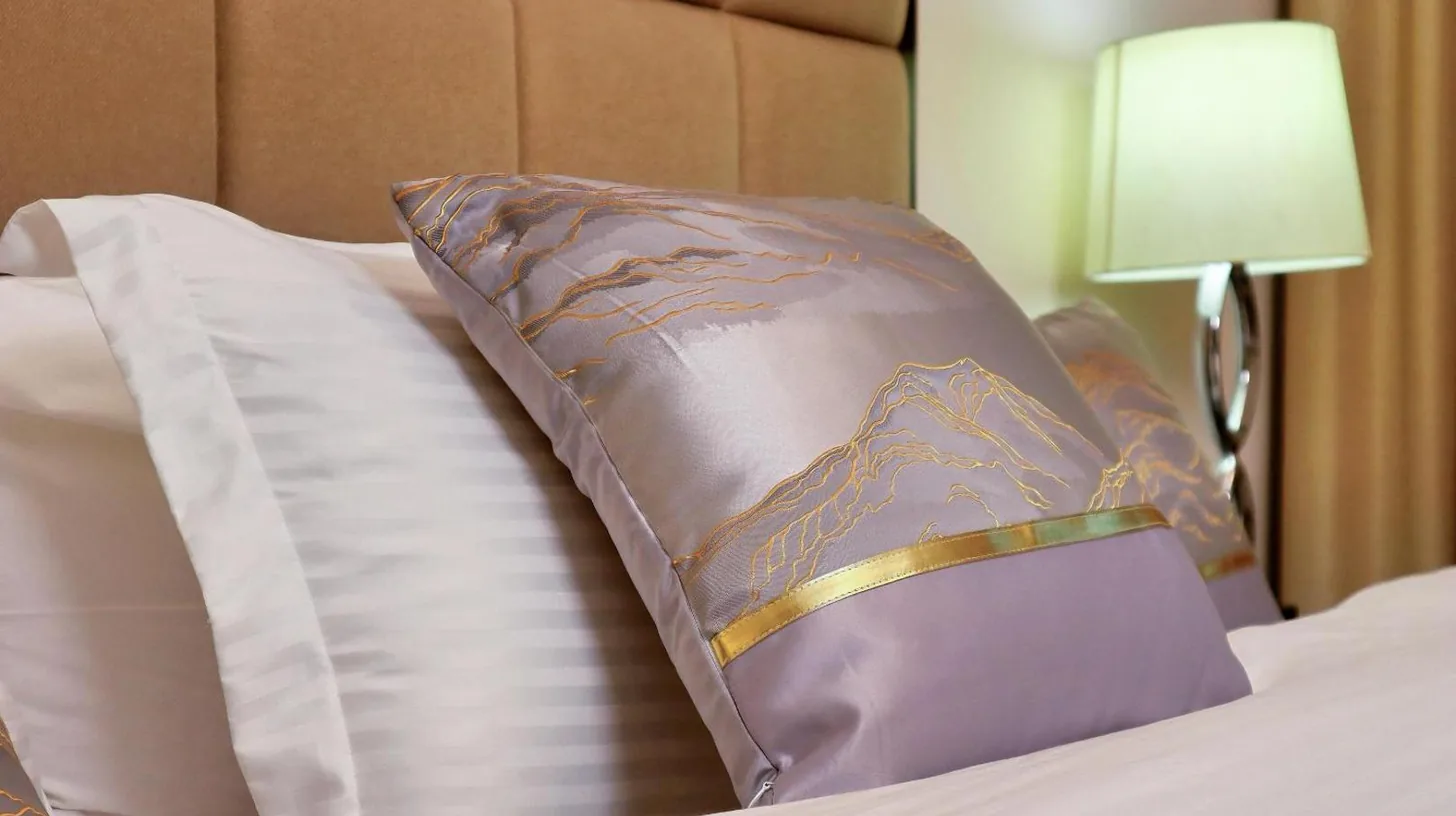 a hotel room with a bed with a dress on it at Full View Burj Khalifa and Fountains -Souk Al Bahar- Dream View holiday Home Rental in Dubai