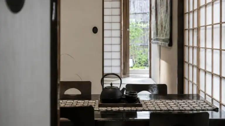 a tea kettle sitting on a table in a room at Futaai Kyoto Machiya Private Villa in Kyoto