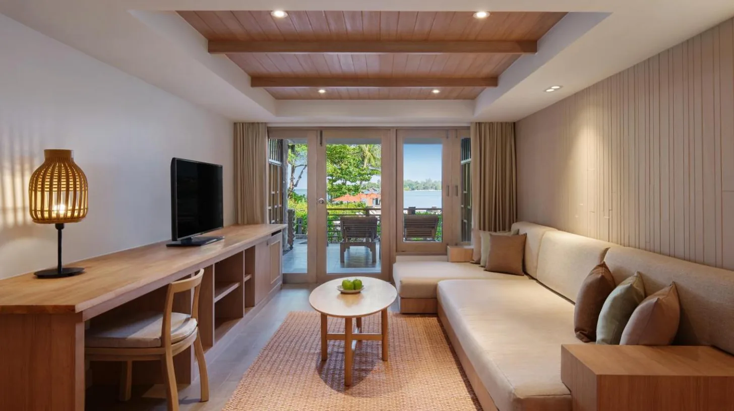 a living room with a couch and a table at Garrya Tongsai Bay Samui in Choeng Mon Beach