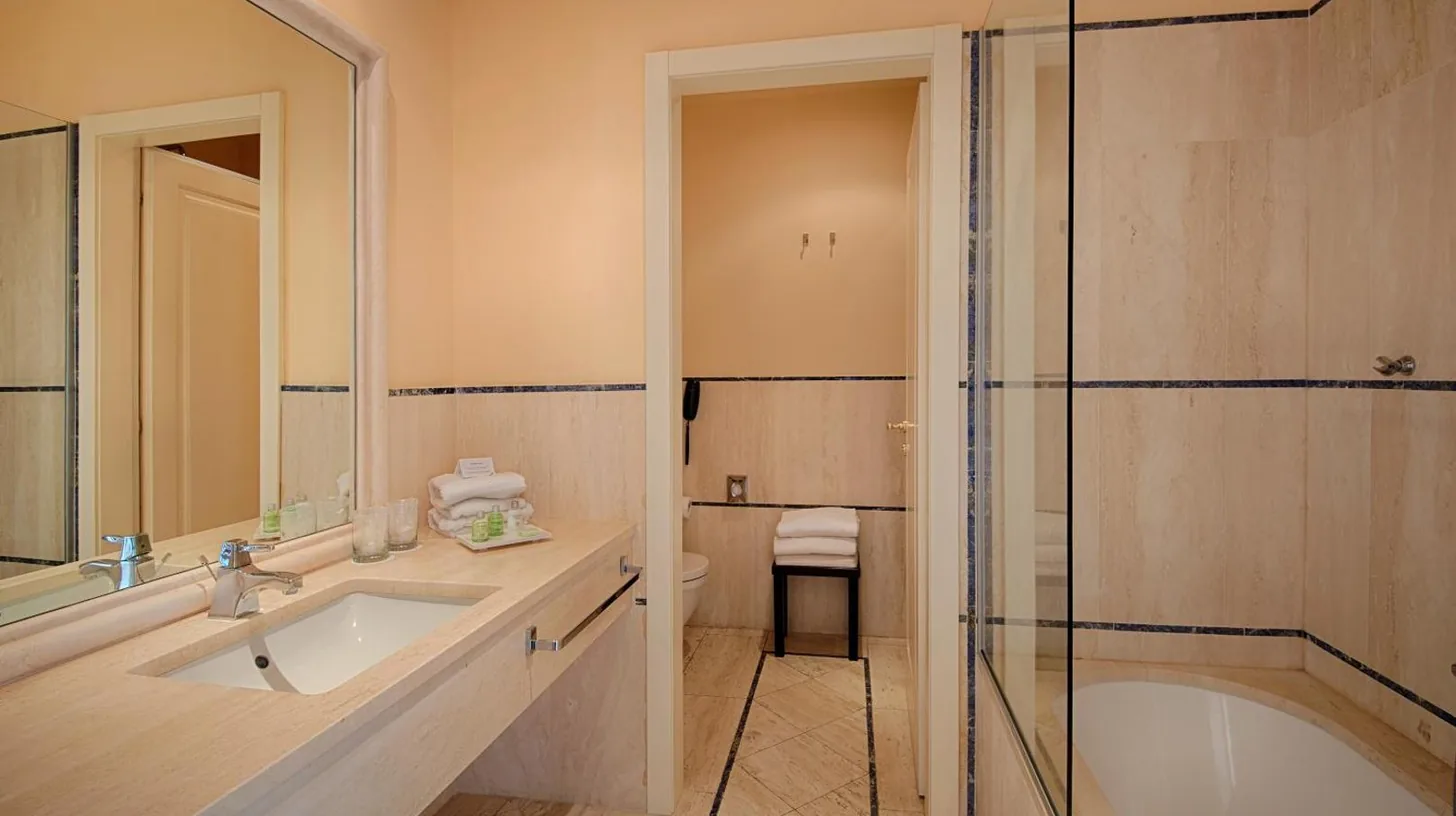a bathroom with a tub and a sink and a shower at GH Palazzo Suite & SPA in Livorno