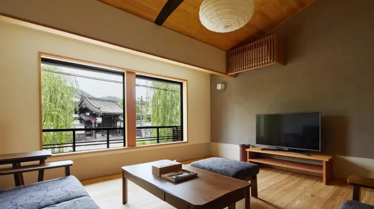 a living room with a couch and a tv at Gion Shirakawa no Yado in Kyoto