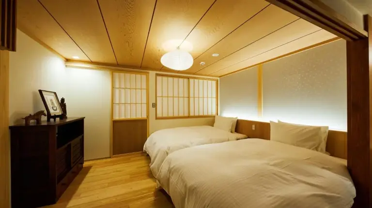 a bedroom with two beds in a room at Gion Shirakawa no Yado in Kyoto