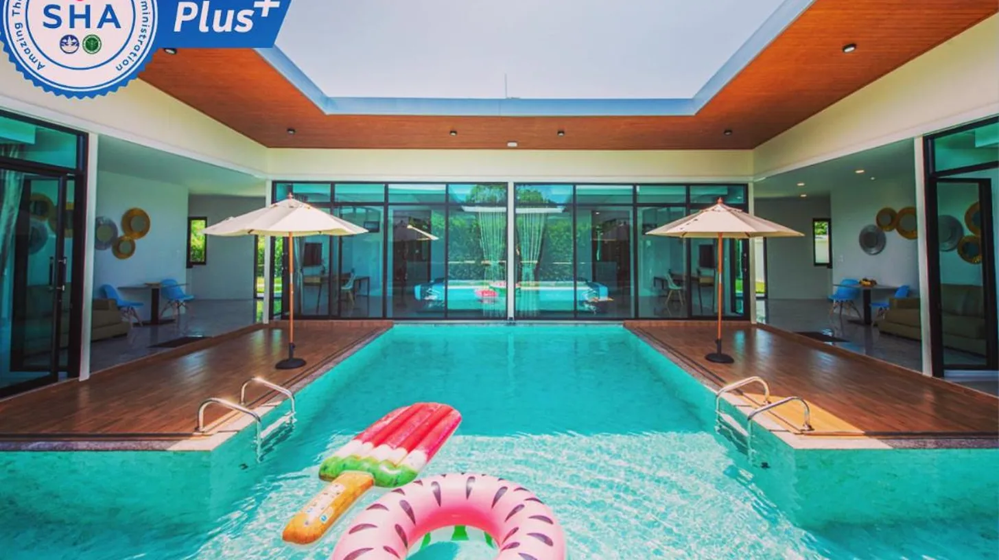 a swimming pool with a pool noodle in the middle at Good Night Pool Villa Phuket in Phuket Town