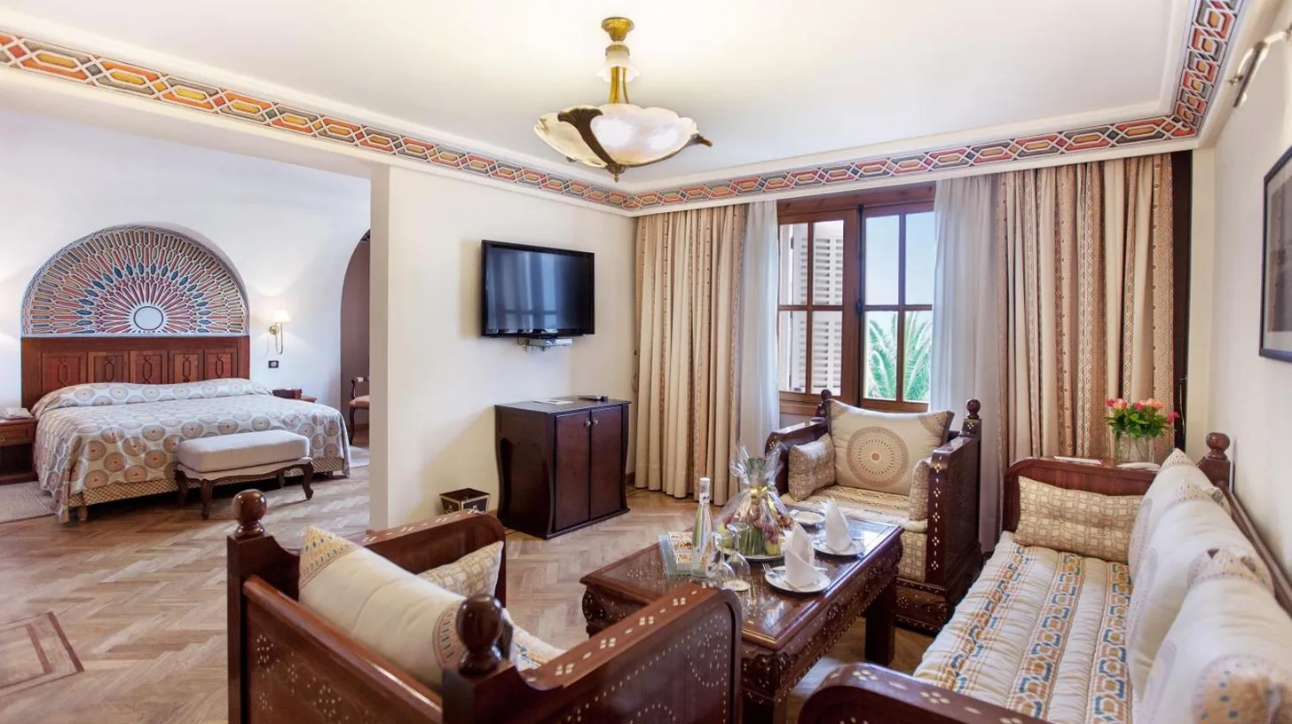a living room with a bed and a couch at Grand Hotel Villa de France in Tangier