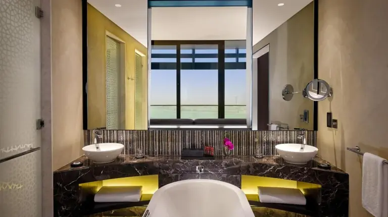 a bathroom with two sinks and a tub and a large mirror at Grand Hyatt Abu Dhabi Hotel & Residences Emirates Pearl in Abu Dhabi