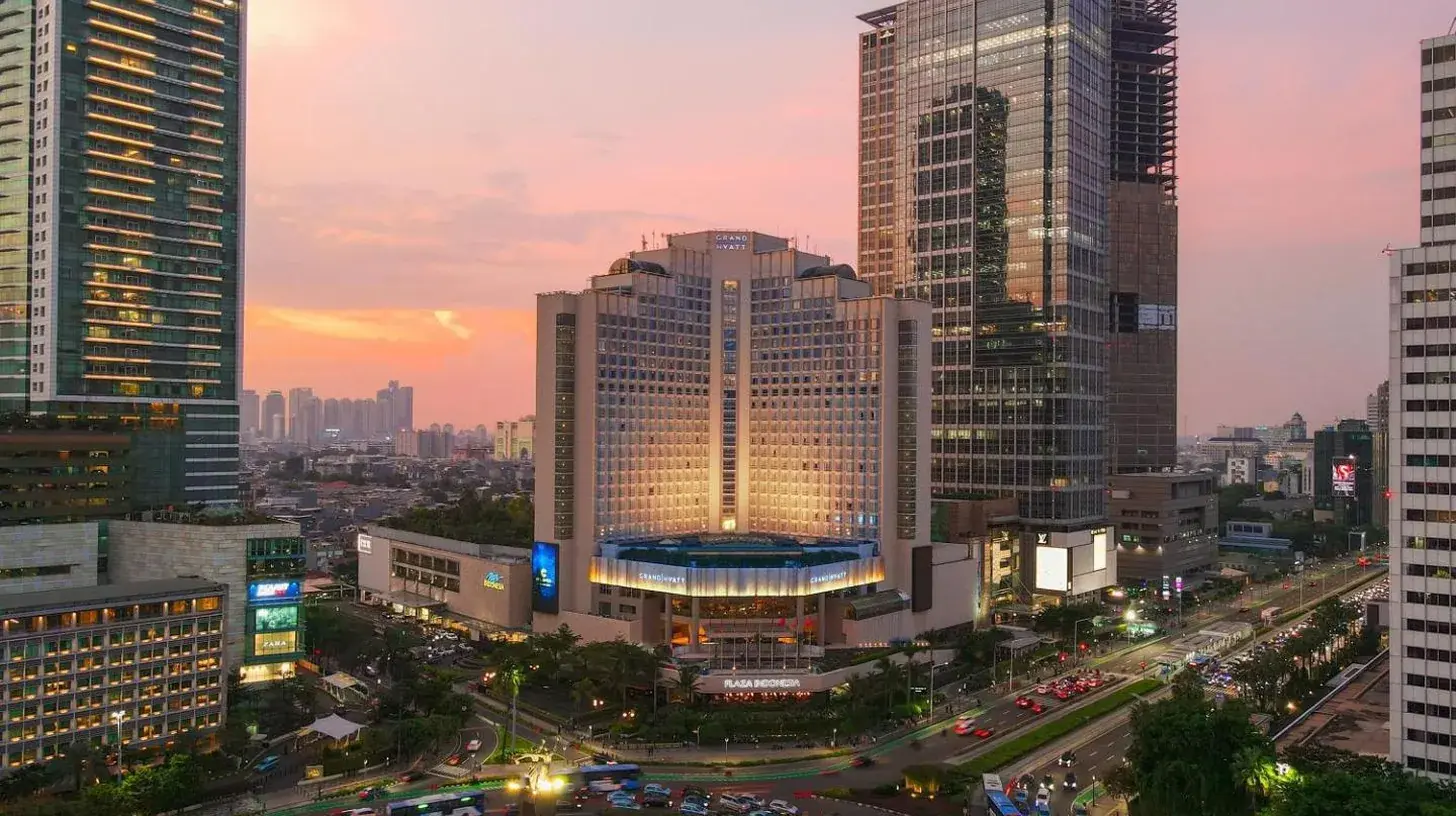 a city skyline with tall buildings and a busy freeway at Grand Hyatt Jakarta in Jakarta