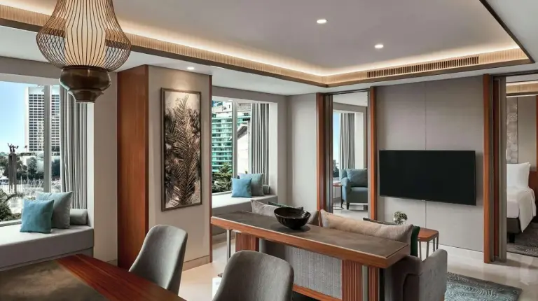 a living room with a dining table and a television at Grand Hyatt Jakarta in Jakarta