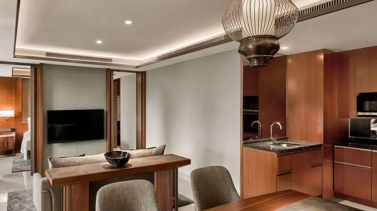 a kitchen and dining room with a table and chairs at Grand Hyatt Jakarta in Jakarta