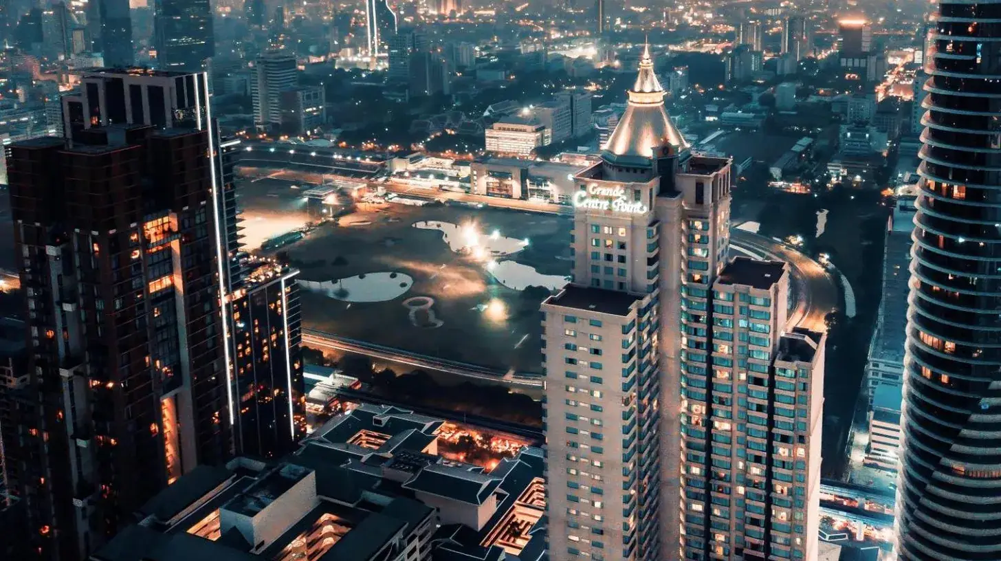 a view of a city at night with tall buildings at Grande Centre Point Hotel Ratchadamri Bangkok in Bangkok