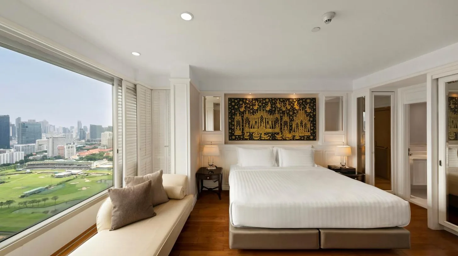 a bedroom with a bed and a large window at Grande Centre Point Hotel Ratchadamri Bangkok in Bangkok