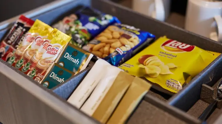 a lunch box with snacks and chips in it at Grande Centre Point Pattaya in Pattaya Central